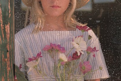 Portrait of girl through screen door