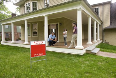 Family on porch of new home