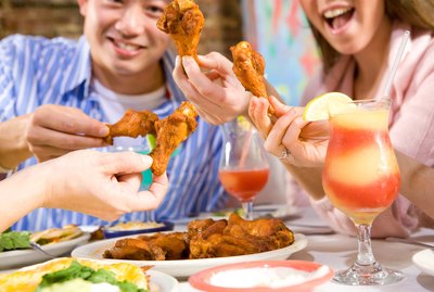 Party of people eating hot wings