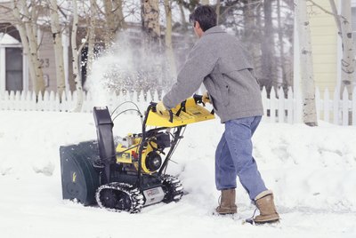 Man clearing sidewalk with snow blower