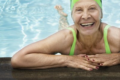 Smiling senior woman swimmer in pool