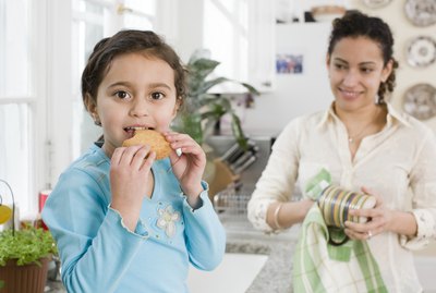 Girl and mother in kitchen
