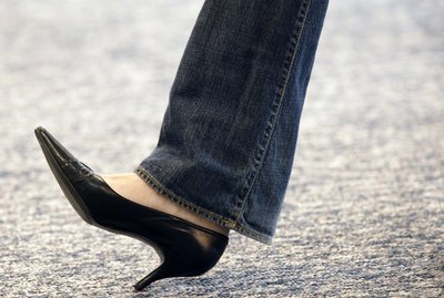 Leg of woman wearing high heels and jeans