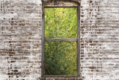 Window frame in decaying brick wall