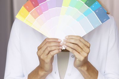 Woman Displaying a Variety of Paint Samples