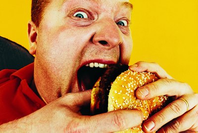 Portrait of a Hungry Man Eating a Hamburger