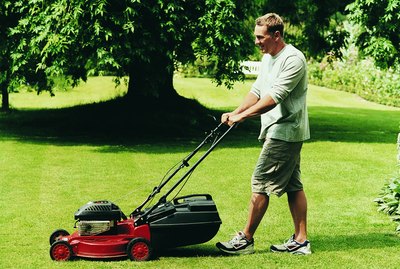 Man Mowing His Lawn During Summer