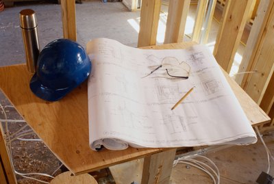 Blueprint and a Hard Hat Inside a Building Frame