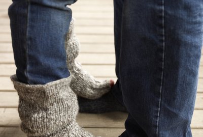 Daughter standing on her father's feet
