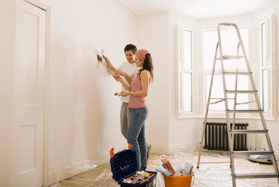 Couple painting wall