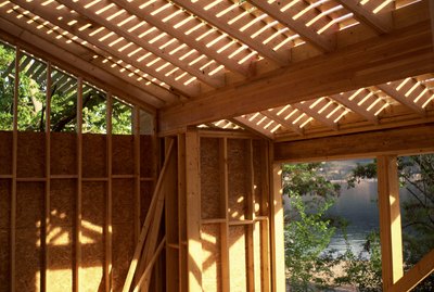 Photo, View looking up through ceiling planks inside a construction site