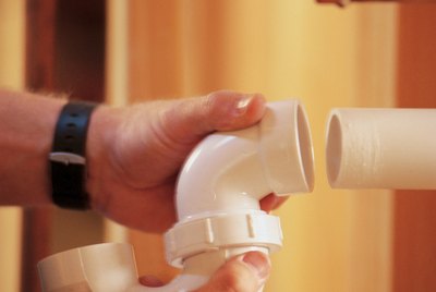 Plumber installing pipe