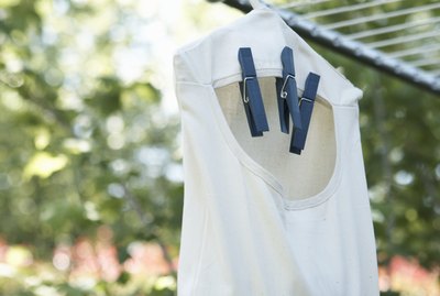Bag of clothespins hanging from clothesline outdoors