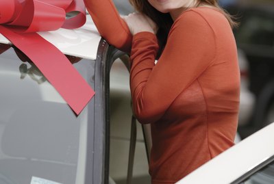 Woman holding keys to new car