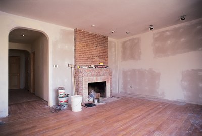 Unfinished living room with fireplace