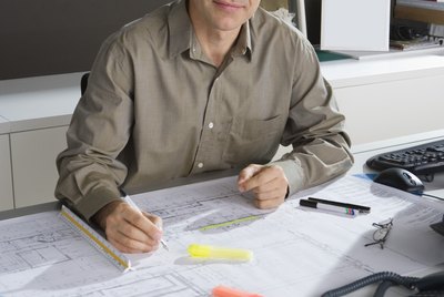 Architect working on blueprints