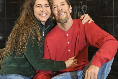 Couple sitting by wood stove