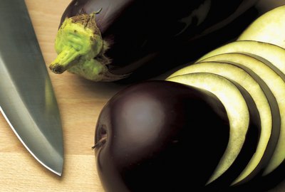 close-up of sliced aubergine with a knife