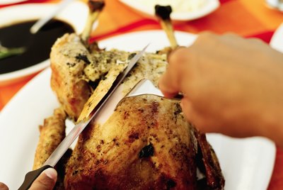 Close-up of a person carving a turkey