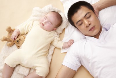 Father and baby (3-6 months) sleeping side-by-side