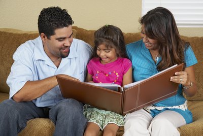 Hispanic family looking at photo album