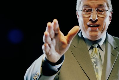 Mature man giving speech, gesturing with hand