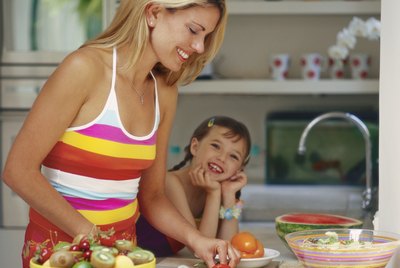 Mother With Her Daughter Preparing Food in a Kitchen