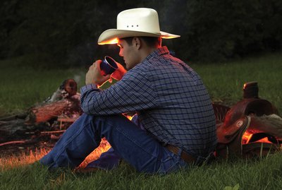 Cowboy near campfire