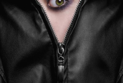 frightened green eyed girl hiding behind the zipper