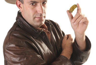 Adventurer treasure hunter with gold nugget