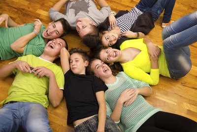 Teenage boys and girls laughing
