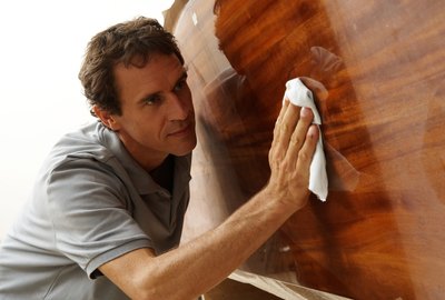 Man polishing boat in workshop