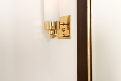 Brass light fixture on wall