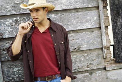 Portrait of a young man wearing a cowboy hat
