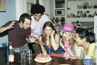 Group of friends admiring cake