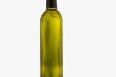 a bottle of olive oil and olives