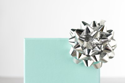 Gift box decorated with silver rosette, close-up
