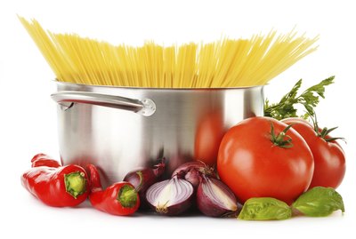 Stainless pot with spaghetti isolated on white