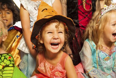 Laughing girl in Halloween costume with friends