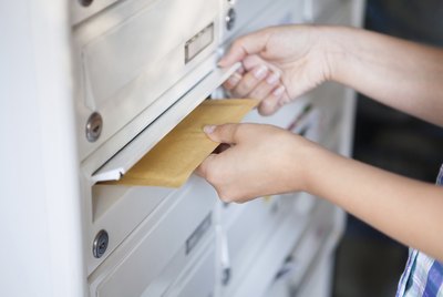 Woman putting envelope in mailbox
