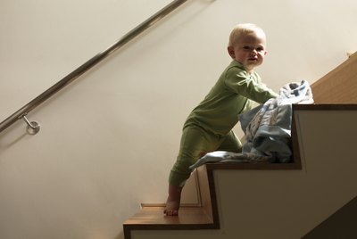 Baby boy with blanket on staircase