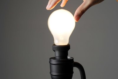 Hand on light bulb