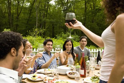 Hispanics at outdoor garden party at country home