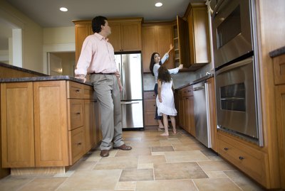Family inspecting kitchen in house for sale