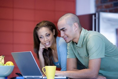 African American couple looking at laptop