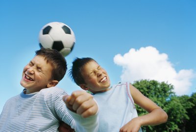 Boys (10-12) playing football