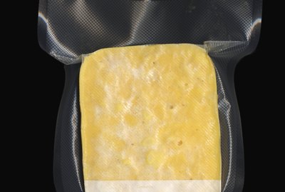Frozen vacuum sealed block of macaroni and cheese