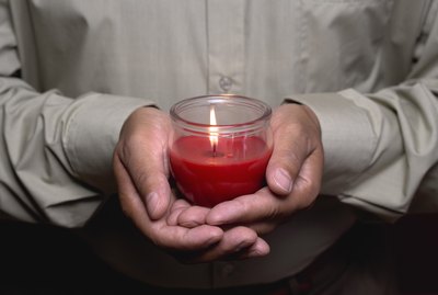 Man holding burning candle