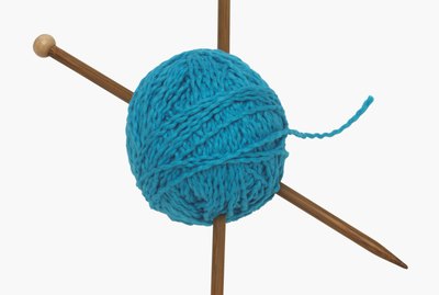 Ball of yarn and knitting needles