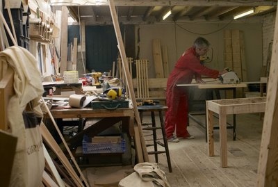 carpenter working in his workshop cutting wood